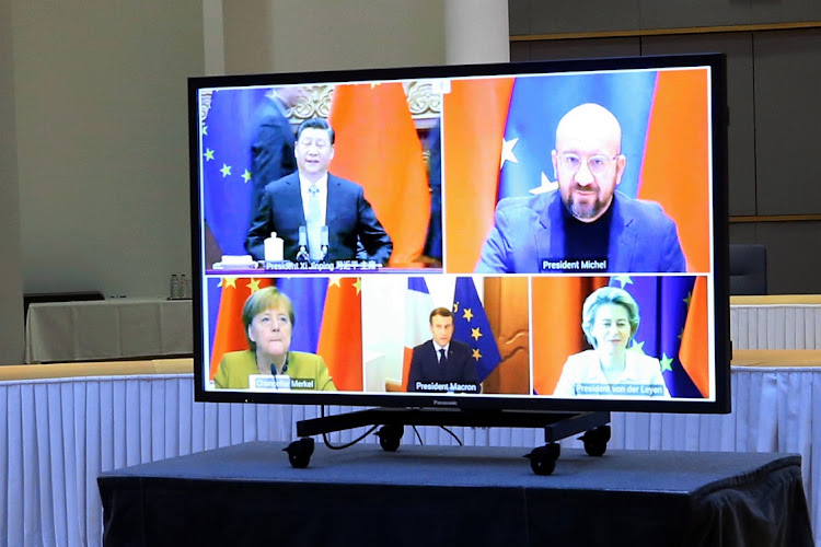 Xi Jinping, China's president, top left, Charles Michel, president of the European Council, top right, Angela Merkel, Germany's chancellor, bottom right, Emmanuel Macron, France’s president, bottom center, and Ursula von der Leyen, European Commission president, on a monitor during a EU-China investment accord virtual meeting in the Europa Building in Brussels, Belgium, on Wednesday.