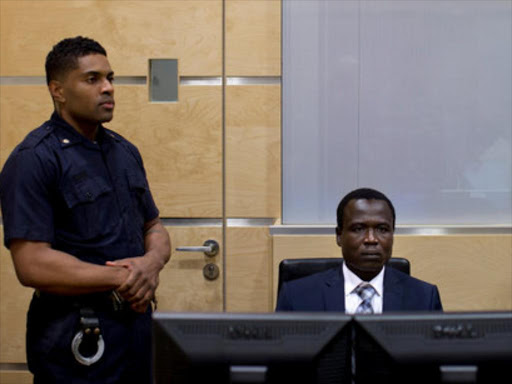 Dominic Ongwen, a Ugandan commander in the Lord's Resistance Army, waits for the start of court procedures as he makes his first appearance at the International Criminal Court in The Hague January 26, 2015. /REUTERS
