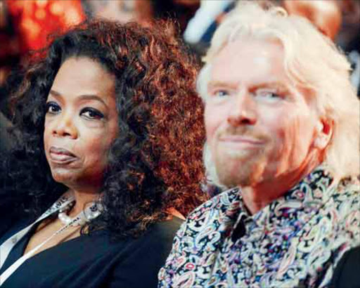 STAR MAGNET: Media mogul Oprah Winfrey and British entrepreneur Sir Richard Branson in Qunu yesterday Picture: REUTERS