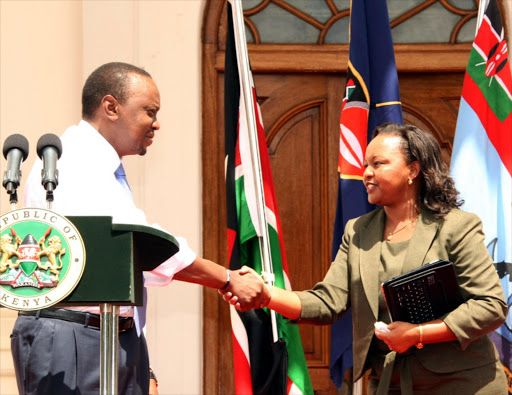 President Uhuru Kenyatta with Former Devolution CS Anne Waiguru. Photo/File