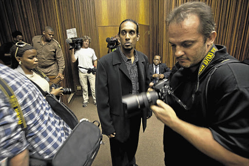 Donovan Moodley is surrounded by photographers at the Johannesburg High Court yesterday, when a judge denied him a retrial for the 2004 kidnapping and murder of student Leigh Matthews Picture: HALDEN KROG