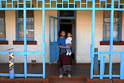 Yonela Mkalipi and her son, Omphile Makubung, outside their home in  Crown Mines village.