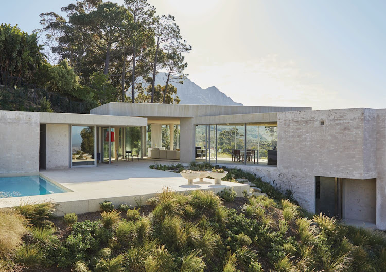 On approach, the house appears as a series of blocks and pavilions emerging from the landscape. It is designed to appear, says Van Niekerk, “half buried, half exposed”. Its parts are arranged in a horseshoe to let light deep into the interiors.