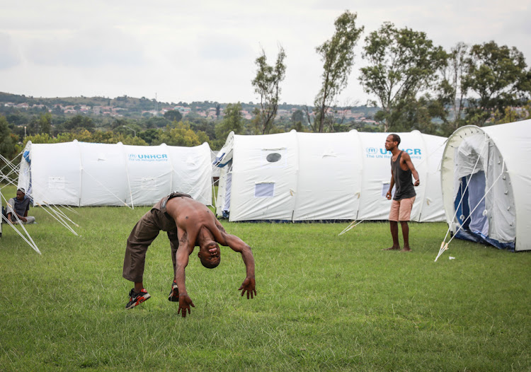 31 March 2020: A man entertains himself doing backflips at the Lucas van den Berg Sports Grounds in Pretoria, where hundreds of homeless people were moved overnight in an effort to curb the spread of Covid-19, to assess the health and living conditions of those living there. The tents are sub-divided with 3 occupants per section.