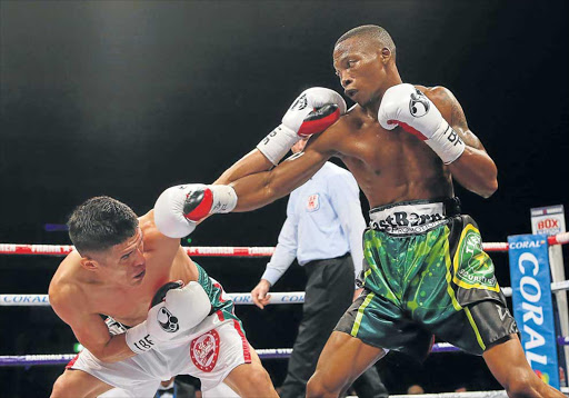 IN FOR KILL: Zolani Tete reaches down as Jose Santos Gonzalez ducks during the IBF International bantamweight Championship bout at the Echo Arena last year in Liverpool Picture: GETTY IMAGES