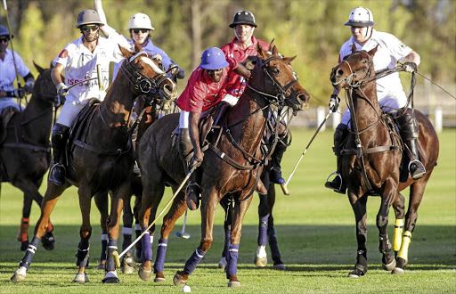 Jabulani Khanyile of the Africa Invitational team (in red) against the World Invitational team at Val de Vie Estate in the Paarl-Franschhoek valley. The South Africans pulled off a tight win of 6-5