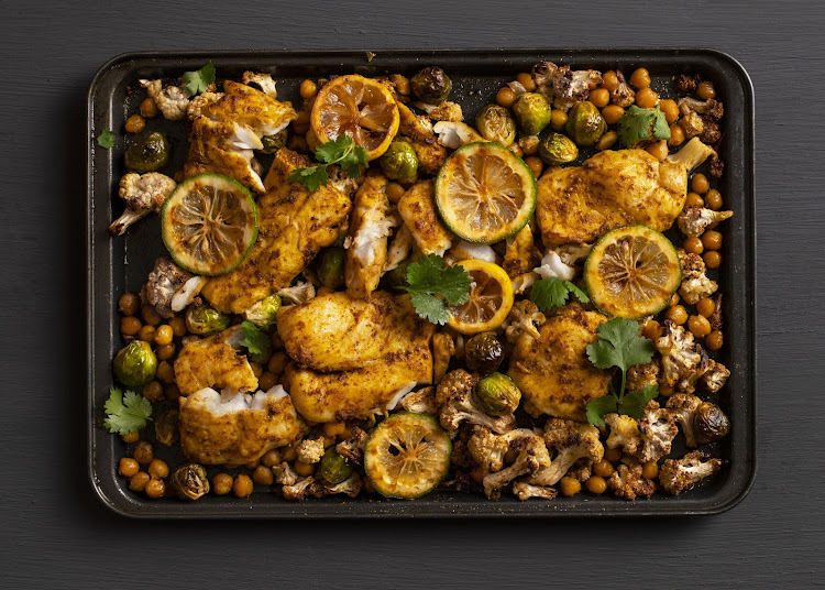 Spicy fish tray bake with roasted cauliflower and chickpeas.