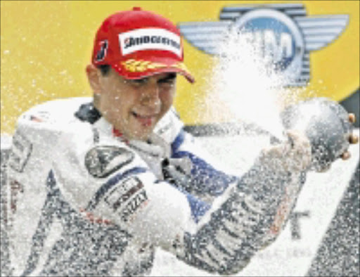 Jorge Lorenzo of Spain sprays champagne after winning the French Grand Prix in Le Mans, western France, Sunday, May 17, 2009. Lorenzo crossed the finish line ahead of Marco Melandri of Italy in second and Dani Pedrosa of Spain in third place. (AP Photo/Michel Spingler)