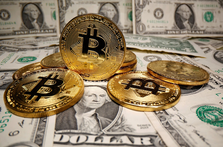 Representations of virtual currency Bitcoin are placed on U.S. Dollar banknotes in this illustration taken May 26, 2020.