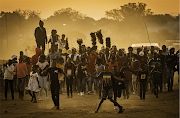 The youngsters and children of the village accompany the initiates as they run through the dusty village at dawn and sunset. The Ndebele Wela only occurs every four years and originally would create a new regiment for the king's army. After their defeat by the Boers in 1883, the Wela was banned.