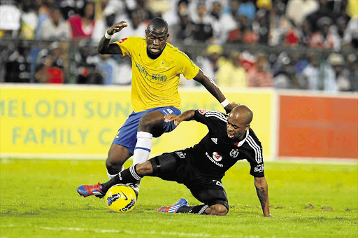 Hlompho Kekana and Oupa Manyisa fight for the ball during the Absa Premiership match between Mamelodi Sundowns and Orlando Pirates on Tuesday. It was the third match in a week for Bucs' new caretaker coach Augusto Palacios and ended goalless Picture: LEFTY SHIVAMBU/GALLO IMAGES