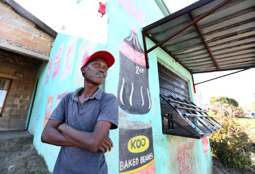 Gift Maseko outside his sister's shop in KwaMashu, Durban. The store, run by a Somali national, was looted in riots on Monday night.