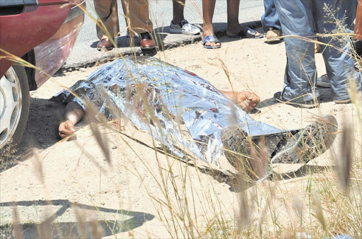 FALLEN: The body of a shooting victim at Mothutlung near Brits, North West. Residents protested yesterday after the Madibeng municipality failed to provide them with water. Police allegedly shot dead two people.