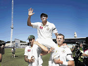 Australia's Mitchell Johnson and Peter Siddle carry team-mate Mike Hussey off the Sydney Cricket Ground at the end of his last Test match yesterday Picture: TIM WIMBORNE/GALLO IMAGES