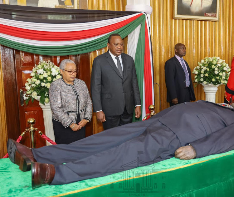 President Uhuru Kenyatta and First Lady Margaret Kenyatta view the body of former President Daniel Moi at Parliament on Saturday, February 8, 2020.