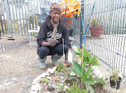 Nonhlanhla Mncube with the small garden she cultivates near her tarpaulin shack in Sea Point, Cape Town, on November 1 2021.
