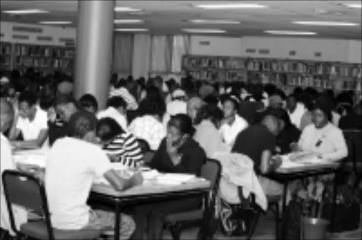 27 OCTOBER 2009 TUESDAY:OVERCROWDED: Due to the small space and shortage of facilities, students are reading their books for their exams preparation at Polokwane Library in Limpopo. However some of students forced their ways after they have spent much time on the queue. PHOTO: ELIJAR MUSHIANA. © Sowetan.