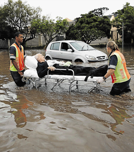 A resident of the Stormhaven Park Retirement Village in Somerset West near Cape Town is taken away on a gurney after the area was hit by flash floods and the Lourens River burst its banks, causing several roads to be closed and leaving scores of people stranded. About 100 residents were evacuated from the village, the manager, Susan Connoway said. As more than 100mm of rain pelted the Western Cape on Friday night, rescue teams worked hard to evacuate patients from a hospital and flood-stricken residents from their homes.