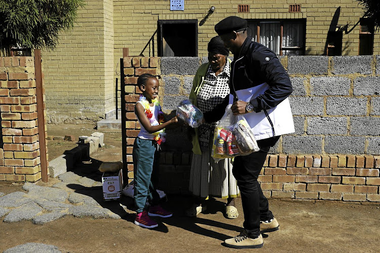 Thoko Doyi and her granddaughter Thuli were among the first in line to inquire about African Children’s Feeding Scheme food parcels.
