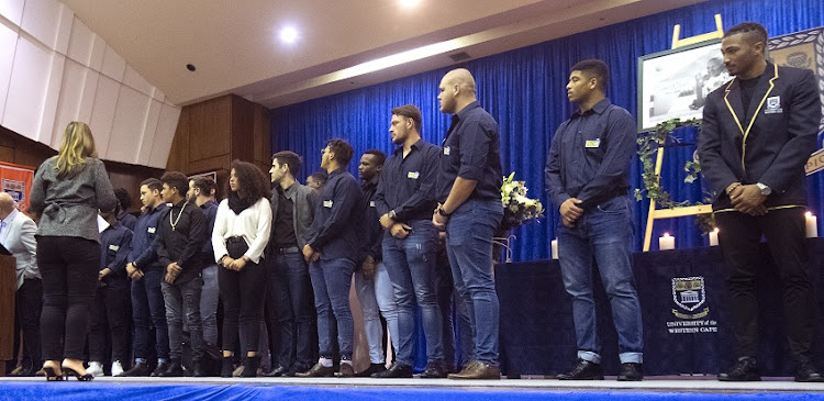 Maria Williams Chester's wife and three children, twins Chloe and Matthew, and Ryan Robson during the memorial service in honour of Springbok hero and University of the Western Cape head rugby coach Chester Williams at the UWC Main Hall on September 11, 2019 in Bellville, South Africa.