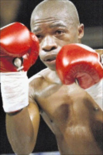 SECUNDA, SOUTH AFRICA: 24 September 2004. South African Flyweight & vacant WBC International title fight between SA champion Ngubela Gwazela (white trunks) and Moruti Mthalane (white trunks with strips) at Graceland Hotel Casino and Country Club in Secunda, South Africa Pictured here is Moruti Mthalane Photo by Lee Warren Gallo Images