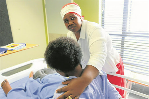 MIRACLE: Lindiwe Ndamase embraces her daughter Luleka, who survived listeriosis, at Frere Hospital yesterday Picture: BHONGO JACOB