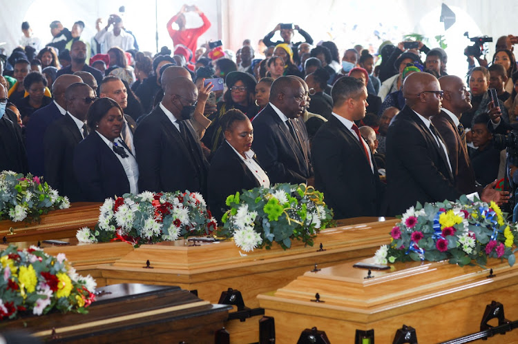 President Cyril Ramaphosa passes empty coffins as he arrives at the mass funeral in the Eastern Cape.