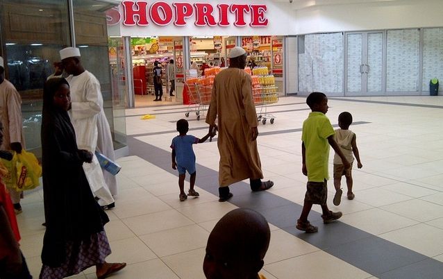 CHANGING TIMES: A family passes a newly-opened Shoprite supermarket in Nigeria’s northern city of Kano. Picture: REUTERS