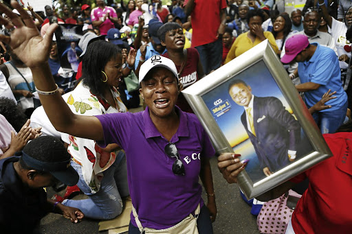 Supporters of church leader Shepherd Bushiri pray outside the Pretoria Specialised Commercial Crimes Court where he appeared on Monday.