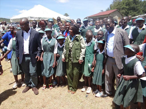 Kenya Forest Service chairman Peter Kinyua, Environment Cabinet Secretary Judi Wakhungu and Baringo Governor Benjamin Cheboi join Chumususu Primary School pupils in a dance during International Forestry Day, March 22, 2016. /FILE