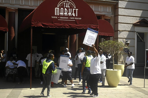 Members of the UASA protest outside of the Market Theater demanding their money.