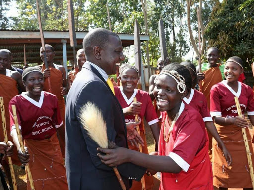 CELEBRATORY JIG: Deputy President William Ruto with students of Toroso High School in Mount Elgon where he was officiating the launch of an empowerment program for infrastructure improvement in the school on February 13, 2016. Photo/DPPS