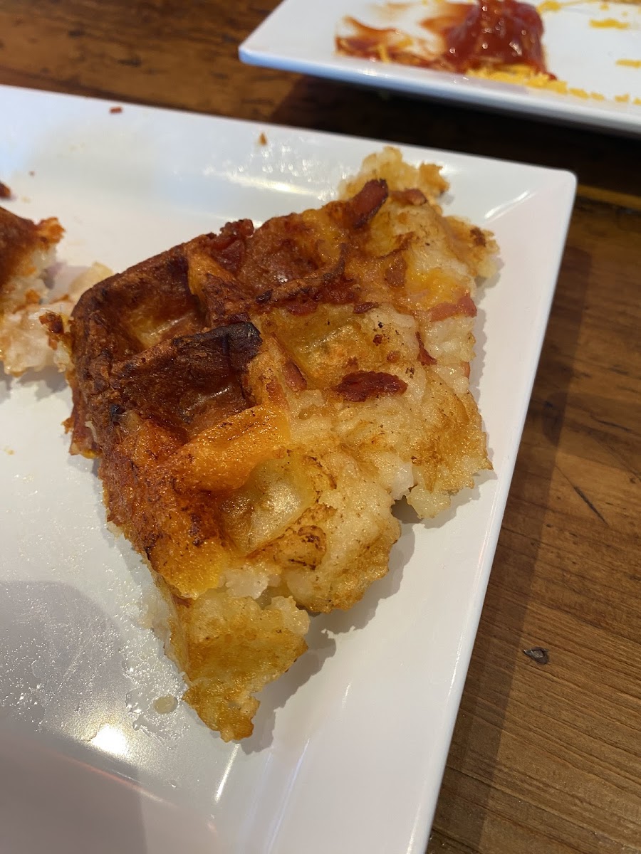 Potato cake (tater tots, bacon, cheese) grilled on a waffle iron