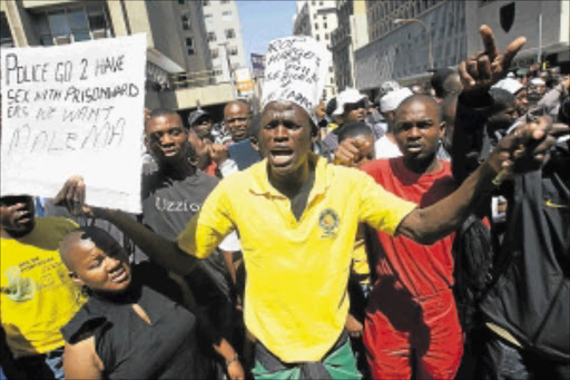 UNPERTURBED: A defiant crowd disperses after Judge Colin Lamont's verdict last year. Photo: Veli Nhlapo