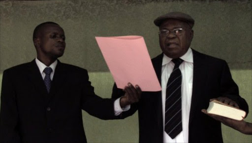 Veteran opposition leader Etienne Tshisekedi (R), who has rejected Joseph Kabila's re-election as the Democratic Republic of Congo's president, holds his own "swearing in" ceremony at his home in the Limete district of Kinshasa on December 23, 2011.