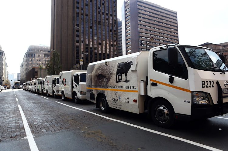 Cash-in-transit vans line up along Beyers Naude Square in Johannesburg where security guards handed over a memorandum demanding safer working conditions after a spate of violent robberies across the country.