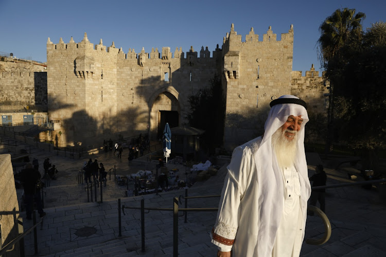 A Muslim man walks at Jerusalem's Damascus Gate during the first day of Ramadan on March 11, 2024 in Jerusalem.