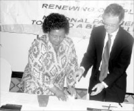 TOUGH STANCE: North West Premier Edna Moewa and the head of the SIU Willie Hofmeyer sign an agreement to cooperate in the fight against corruption in the province. Pic. Boitumelo Tshehle. © Sowetan.