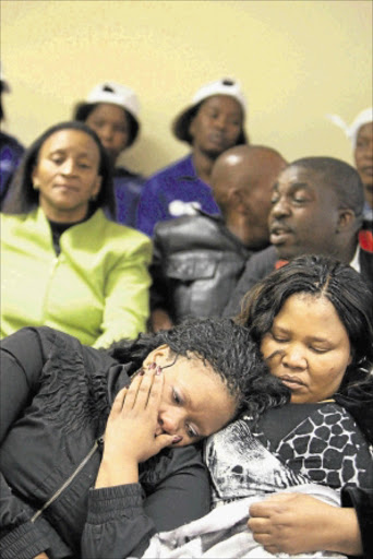 GRIEF STRICKEN: Rose Tatane is supported by her late husband's cousin Madieketseng Nthodi. PHOTO: ANTONIO MUCHAVE