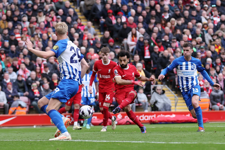 Mohamed Salah of Liverpool scores his team’s second goal during the Premier League match against Brighton at Anfield, in Liverpool, on Sunday. Picture: ALEX LIVESEY/GETTY IMAGES