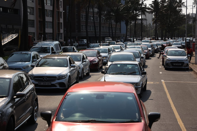 Striking Transnet workers use their cars to block the road at Durban's Victoria Embankment.