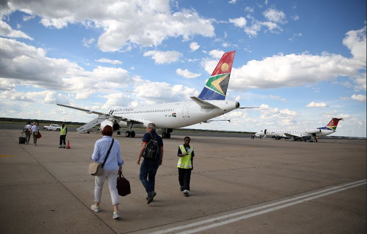 Passengers board a South African Airways aircraft.