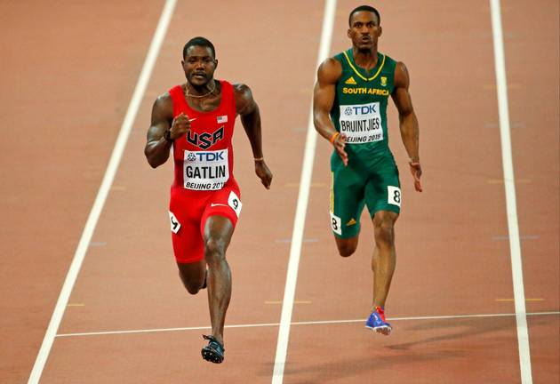 Justin Gatlin of the US (L) and Henricho Bruintjies of South Africa compete in the men's 100 metres heats during the 15th IAAF World Championships. File photo