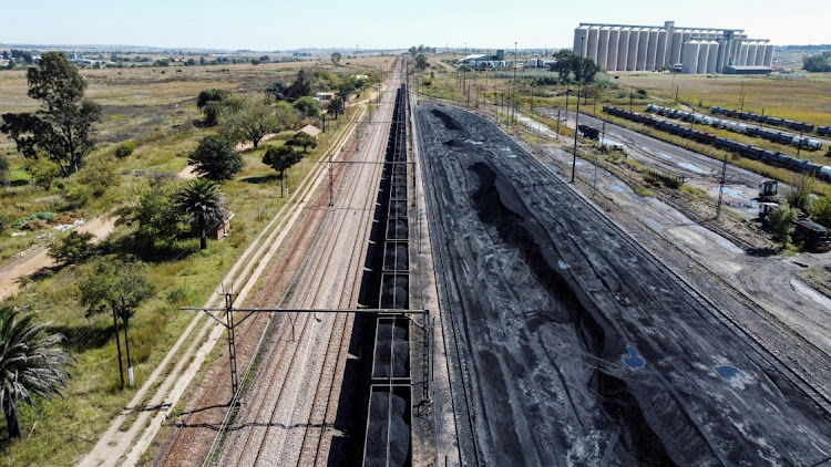 A Transnet Freight rail line, next to tonnes of coal from the nearby Khanye Colliery, at the Bronkhorstspruit station. File photo
