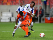 Vusi Mthimkulu of Witbank Spurs gets between Lerato Manzine of Chippa United and the ball during the Nedbank Cup last 32 match between Chippa United and Witbank Spurs at Nelson Mandela Bay Stadium on March 15, 2017 in Port Elizabeth, South Africa.