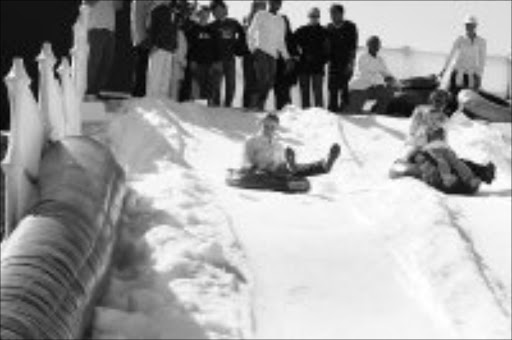 ICY ENTERTAINMENT: Kids slide down the slope at the 'Snow in the City' event at Mary Fitzgerald Square in Newtown. Pic. Vathiswa Ruselo. 22/06/08. © Sowetan