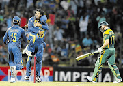 NEMESIS: Sri Lanka's Tillakaratne Dilshan, second from left, celebrates with captain Angelo Mathews and Sachithra Senanayake (18) after taking the wicket of South Africa's AB de Villiers during the sides' second one-day international match in Pallekele yesterday