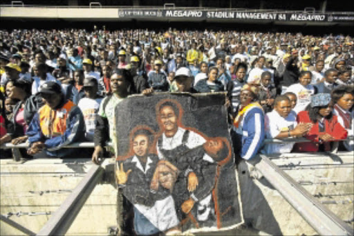 SACRIFICE: People at the 2011 Youth Day rally at Orlando Stadium with the poster of the first victim of the June 16 massacre, Hector Pieterson. President Jacob Zuma and then ANC Youth League president Julius Malema arrived at an almost empty stadium - four hours late. The crowd had gone home. Photo: HALDEN KROG