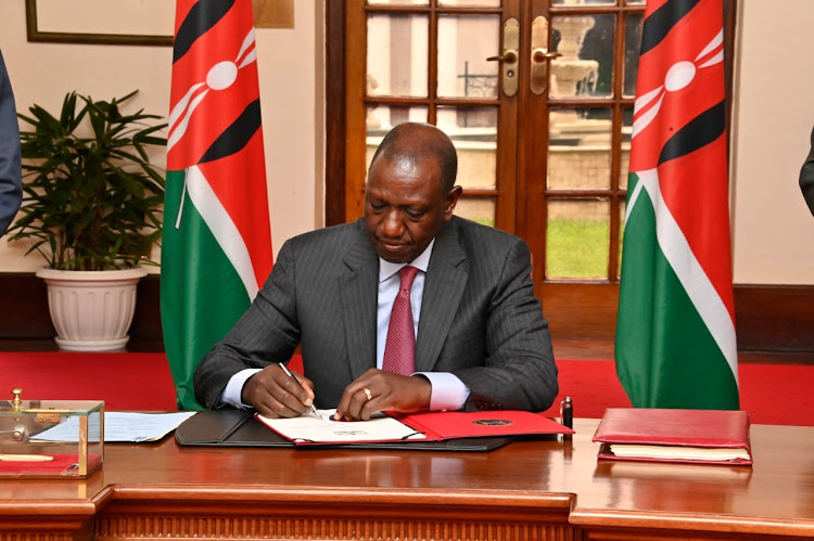 President William Ruto when he assented into law the Insurance amendment bill, 2023.