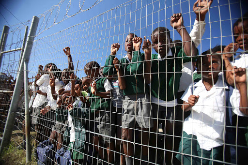 FENCED OUT: Embekweni Primary School, in Fort Jackson was shut down on Friday after parents and pupils protested about the lack of scholar transport in the area Picture: MARK ANDREWS